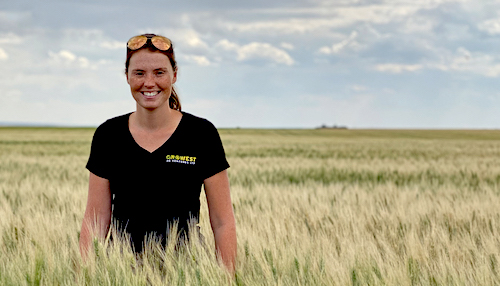 Shannon Winny, owner of GroWest, standing in the field facing the camera