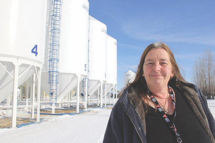 Image of Morag Marjerison standing in front of grain silos 